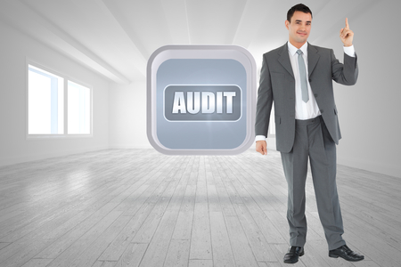 Businessman pointing upwards against bright room with opened windowsの写真素材