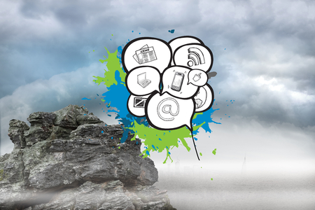 Apps in speech bubbles on paint splashes against rocky landscapeの写真素材