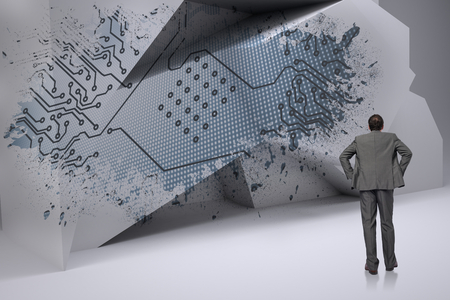 Businessman with hands on hips against splash showing circuit boardの写真素材