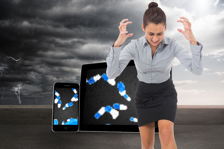 Furious businesswoman gesturing against balcony and stormy skyの写真素材