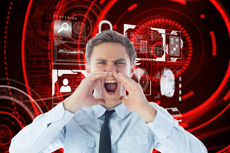 Angry businessman shouting against shiny red circles on black backgroundの写真素材