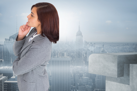 Focused businesswoman against misty cityscapeの写真素材