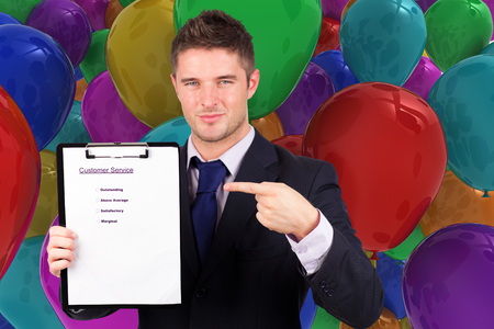 Businessman with customer service report against colourful balloonsの写真素材