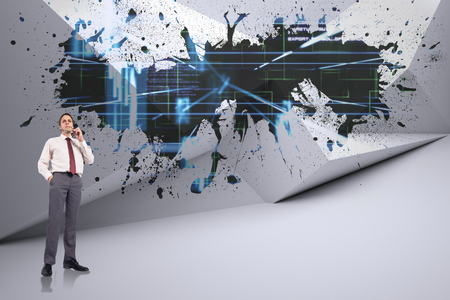 Thinking businessman holding glasses against splash showing technology interfaceの写真素材