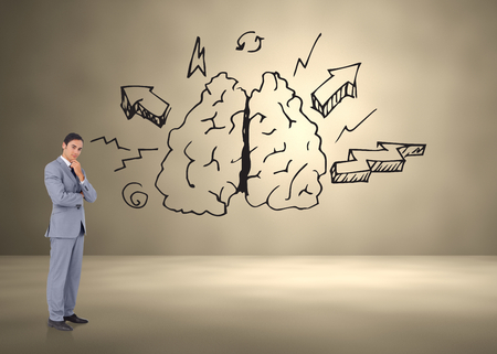 Thoughtful businessman smiling with folded arms against lungs and arrows doodleの写真素材