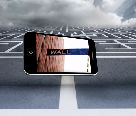Wall street on smartphone screen against big 3d maze under cloudsの写真素材