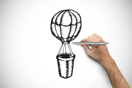 Hand holding a silver pen against white background with vignetteの写真素材