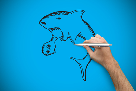 Hand holding a silver pen against blue background with vignetteの写真素材