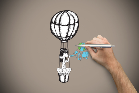 Hand holding a silver pen against grey background with vignetteの写真素材