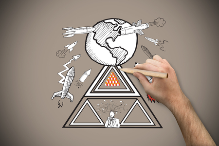 Hand holding a pencil against grey background with vignetteの写真素材