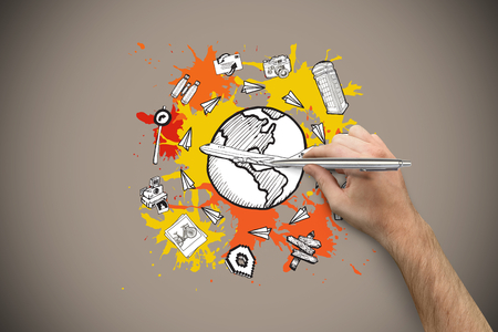 Hand holding a silver pen against grey background with vignetteの写真素材