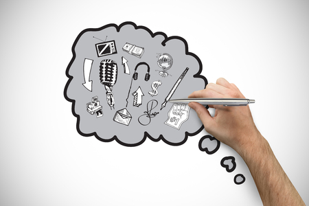 Hand holding a silver pen against white background with vignetteの写真素材