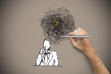 Hand holding a silver pen against grey background with vignetteの写真素材