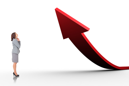 Smiling thoughtful businesswoman against red arrow pointing upの写真素材