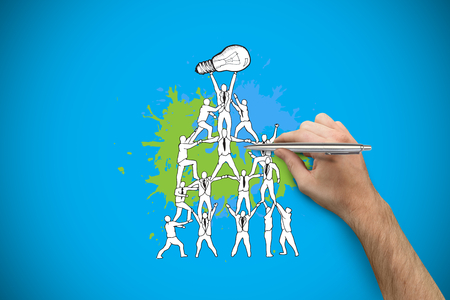 Hand holding a silver pen against blue background with vignetteの写真素材