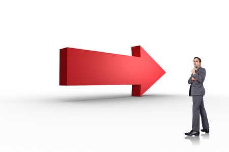 Thoughtful businessman holding pen to chin against red arrow の写真素材
