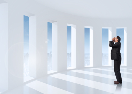 Shouting businessman against bright white room with windowsの写真素材