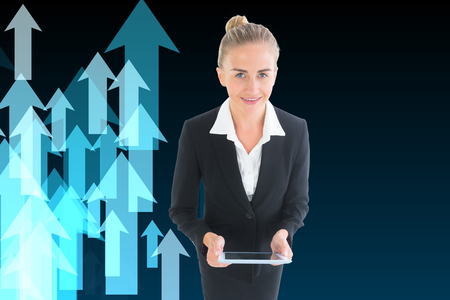 Composite image of blonde businesswoman holding new tabletの写真素材