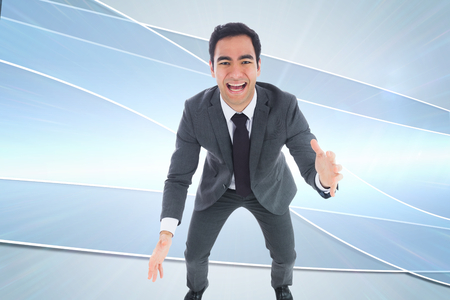 Composite image of excited businessman catchingの写真素材