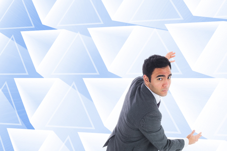 Composite image of unsmiling businessman catchingの写真素材