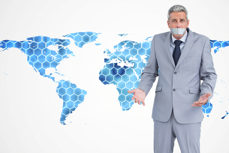 Composite image of businessman gagged with adhesive tape on mouthの写真素材