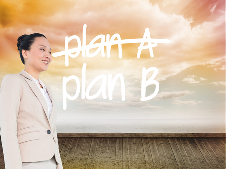 Composite image of smiling asian businesswoman walkingの写真素材