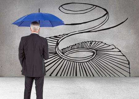 Composite image of mature businessman holding umbrellaの写真素材