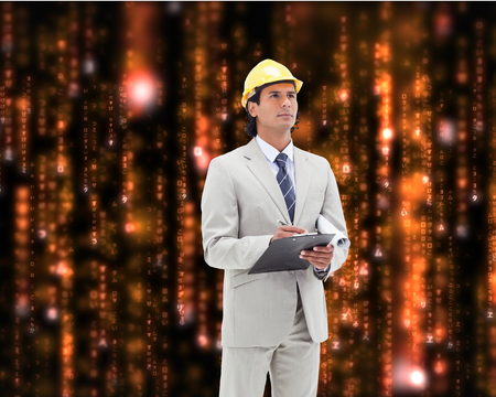 Composite image of attractive architect taking notesの写真素材