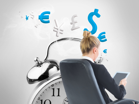 Composite image of blonde businesswoman sitting on swivel chair with tabletの写真素材