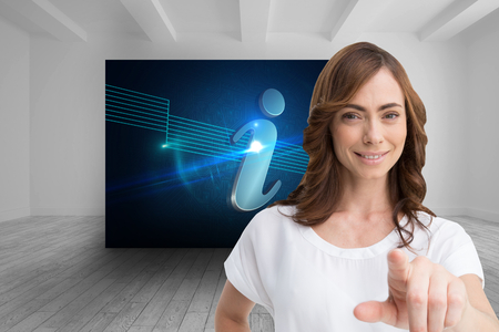 Composite image of attractive happy brunette pointingの写真素材