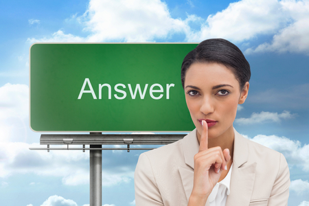 Composite image of young businesswoman asking for silence on white backgroundの写真素材