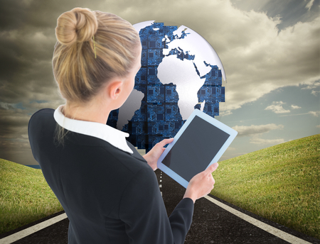 Composite image of blonde businesswoman holding tabletの写真素材