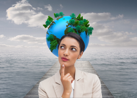 Composite image of smiling businesswoman thinkingの写真素材