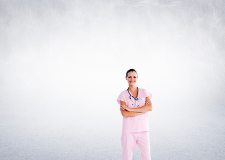 Composite image of isolated beautiful nurse standing in front of the camera with folded armsの写真素材