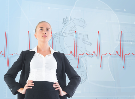 Composite image of blonde businesswoman standing with hands on hipsの写真素材