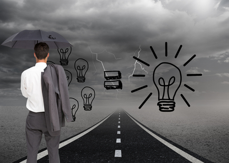 Composite image of businessman standing back to camera holding umbrella and jacket on shoulder against white backgroundの写真素材
