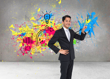 Composite image of smiling asian businessman pointingの写真素材