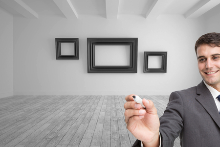 Composite image of young businessman writing somethingの写真素材