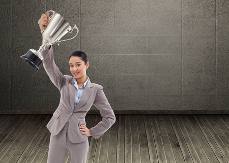Composite image of portrait of a businesswoman showing a cupの写真素材
