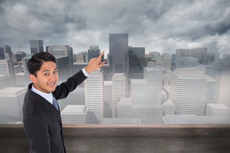 Composite image of smiling asian businessman pointingの写真素材