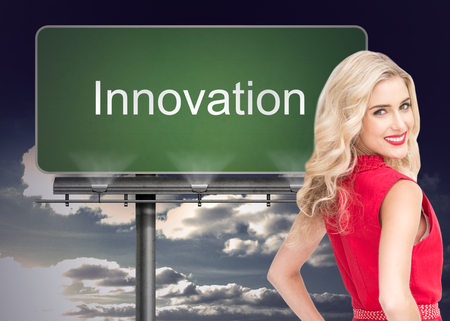 Composite image of smiling attractive blonde standing hands on hipsの写真素材