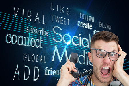 Composite image of portrait of frustrated computer engineer screaming while on call in front of open cpuの写真素材