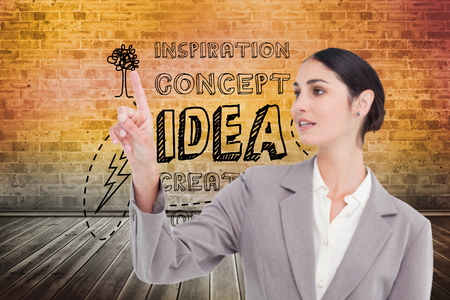 Composite image of young saleswoman operating touchscreenの写真素材