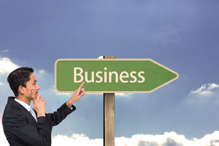 Composite image of thoughtful asian businessman pointingの写真素材