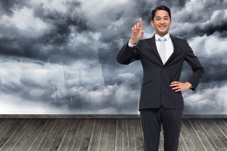 Composite image of smiling asian businessman pointingの写真素材