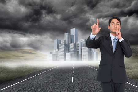 Composite image of thoughtful asian businessman pointingの写真素材