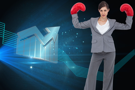 Composite image of businesswoman with boxing glovesの写真素材