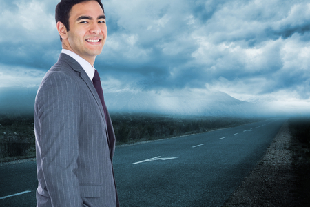 Composite image of smiling businessman standingの写真素材