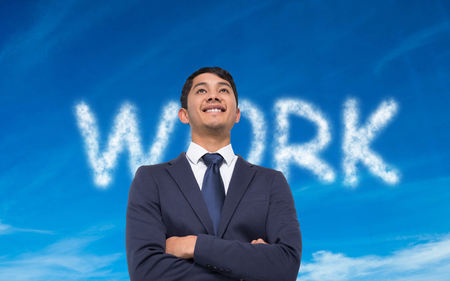 Composite image of smiling asian businessman with arms crossedの写真素材