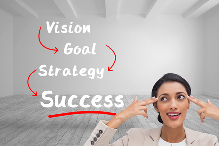 Composite image of confident young businesswoman pointing her head with her fingersの写真素材